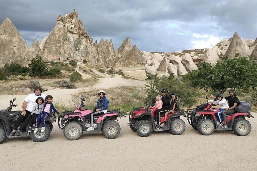 A group of people on ATVs in a desert landscape with distinctive rock formations. 2
