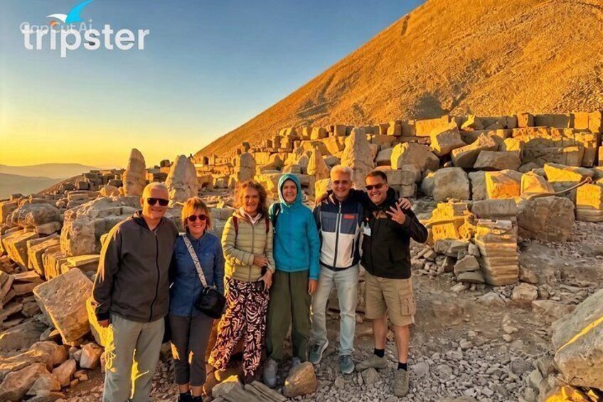A group of people standing among large stone blocks in a mountainous area. 2