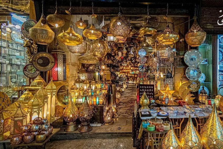 A shop with various hanging and displayed lanterns and pottery. 2