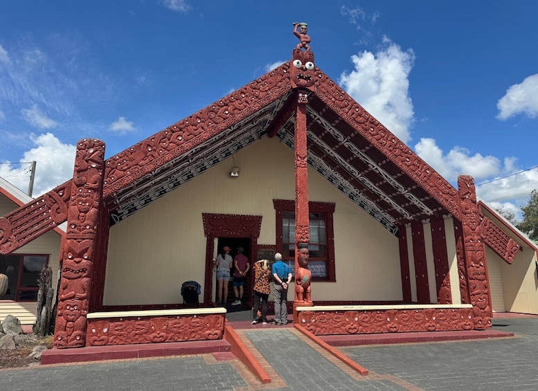 A building with intricate red carvings and a traditional design. 2