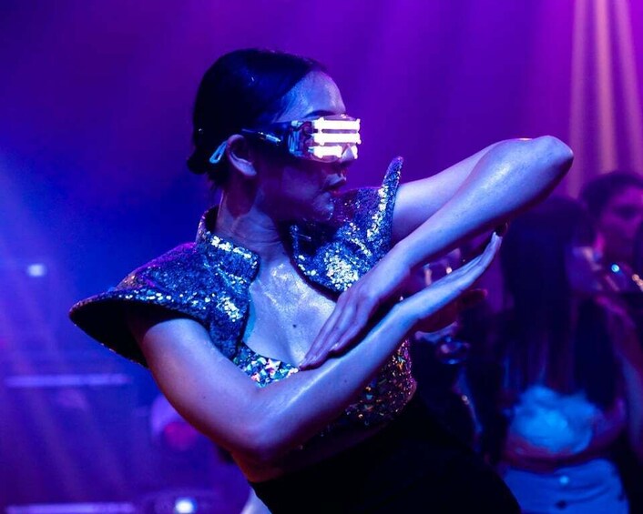 A person in a sequined outfit performing on stage. 1