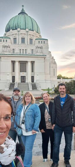 A group of people standing in front of a large building with a dome and columns. 2