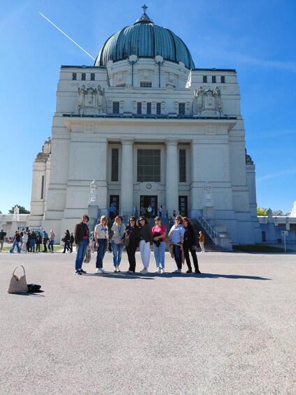 A large white building with a green dome and columns in front. 3