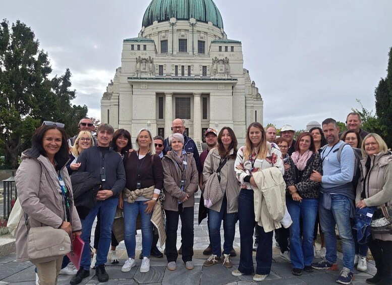 A group of people standing in front of a large, historic building with a dome. 2