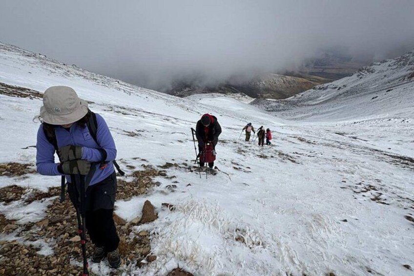 A group of hikers on a snowy mountain trail. 2