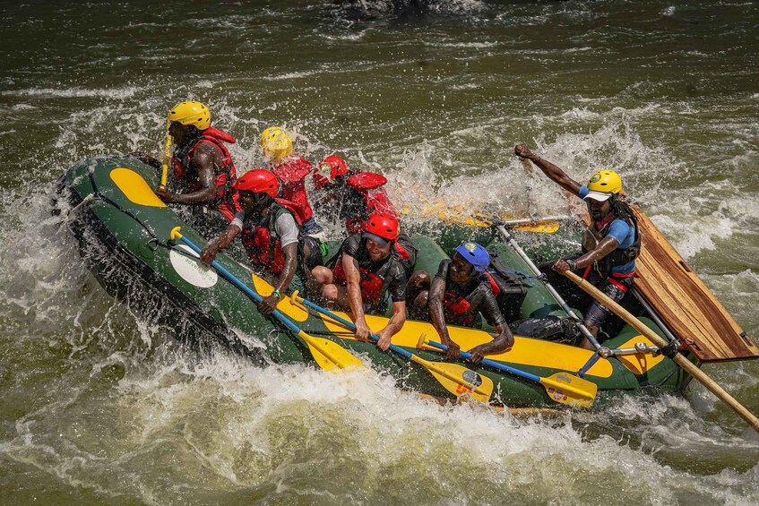A group of people in a raft navigating through rough waters. 1