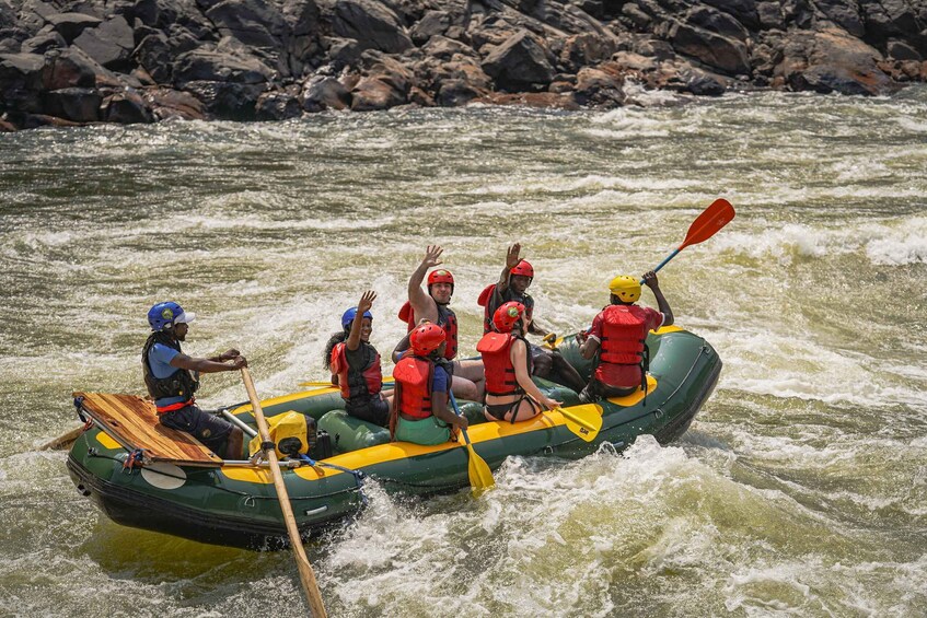 A group of people in a raft navigating a river with rapids. 4