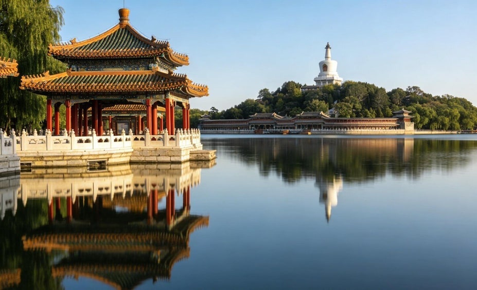 A traditional Chinese pavilion by a calm lake, a white pagoda on a hill, and a large walled complex in the background. 2