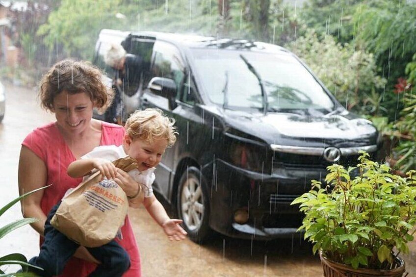 Kid trying to experience Kigali's rain.Parenting is amazing 5
