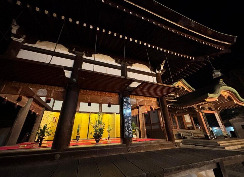 A traditional Japanese building at night with illuminated lanterns and a red carpet. 2