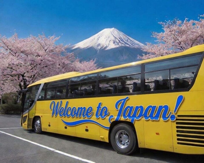 A yellow bus with 'Welcome to Japan!' written on it, parked in front of a snow-capped mountain. 3