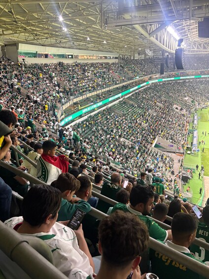 A crowded stadium with spectators seated in rows. 3