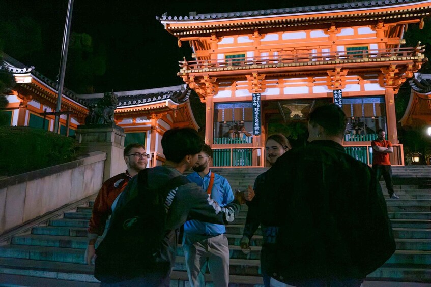 A traditional Japanese building with a red roof and wooden structure, surrounded by steps and greenery. 5