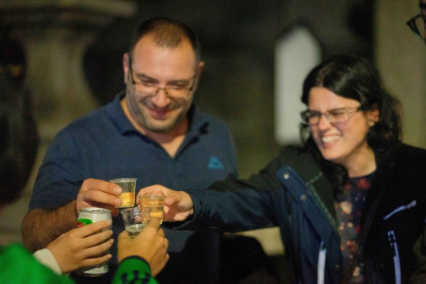 A man and a woman toasting with drinks. 4