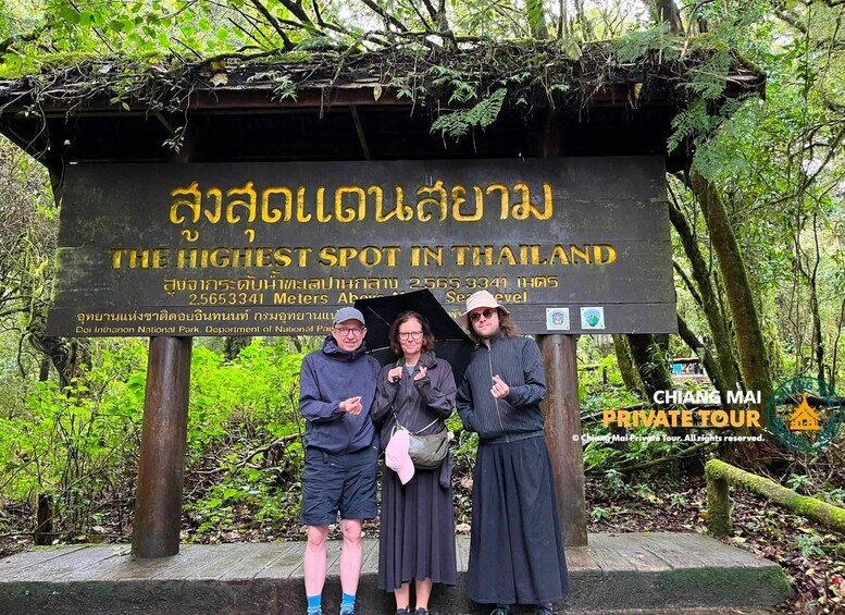 A sign for the highest spot in Thailand, surrounded by lush greenery. 2