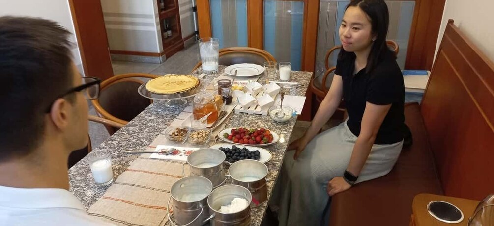 A dining table with food, drinks, and utensils. 4