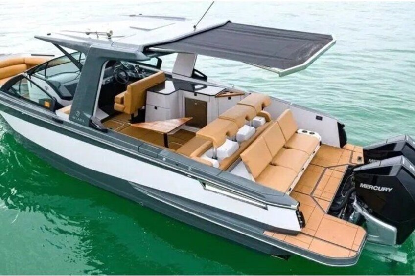 A motorboat with a cabin, seating area, and outboard motor. 4
