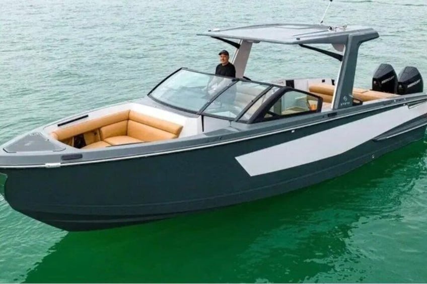 A sleek, modern motorboat with a covered cabin, comfortable seating, and a single motor. 1