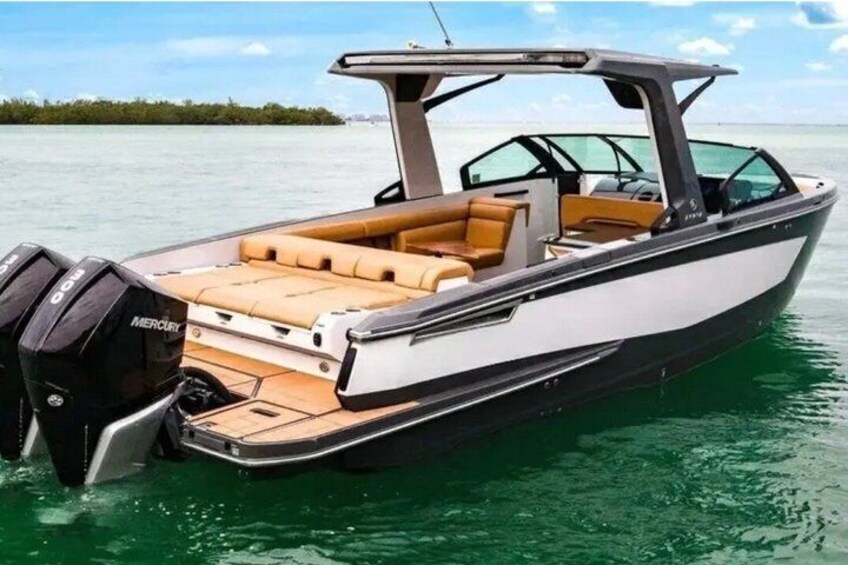 A speedboat with a cabin, a Mercury outboard motor, and a tan interior. 5