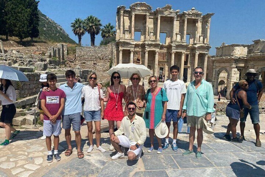 A group of people standing in front of ancient ruins with columns and arches. 5