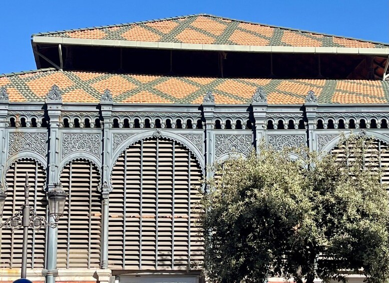 A building with ornate arches and a tiled roof. 3