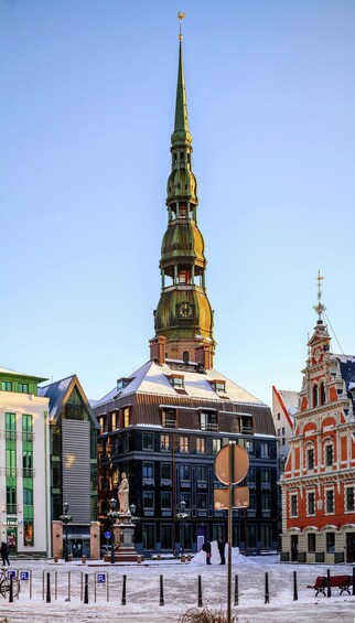 A historic building with a green spire and a clock tower. 2
