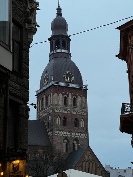 A historic building with a prominent clock tower and a dome. 5