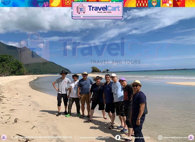 A group of people on a beach with a clear sky and mountains in the background. 5