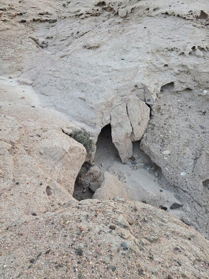 A rocky terrain with a large cave entrance. 5