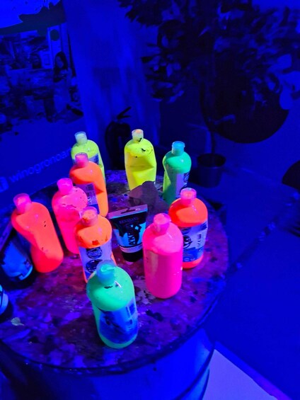 A collection of colorful plastic bottles on a table. 4