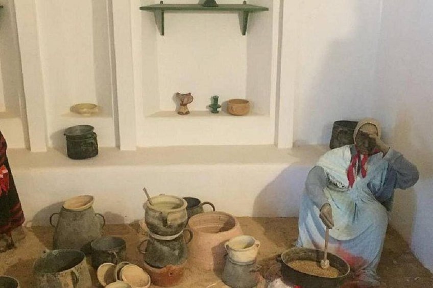 A person sitting on the floor surrounded by various pots and bowls. 4