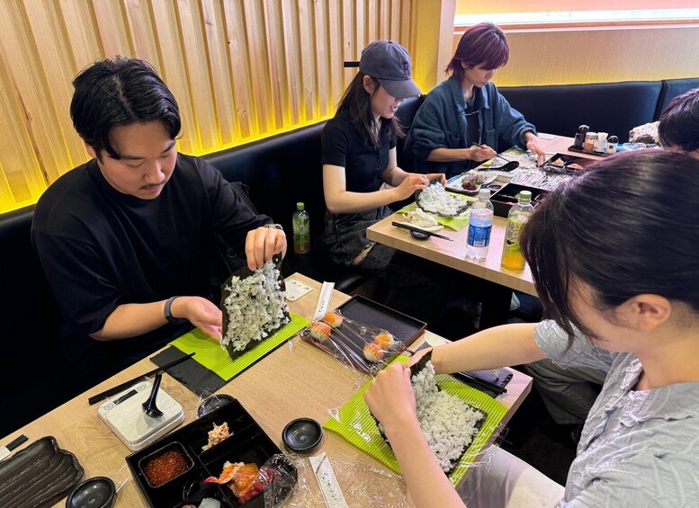 People preparing sushi at a restaurant. 3