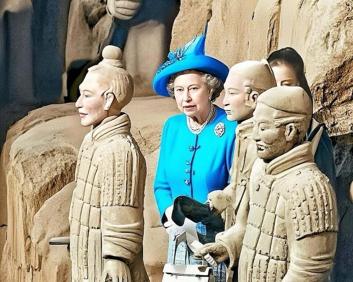 A person in a blue outfit and hat standing in front of a stone sculpture. 1