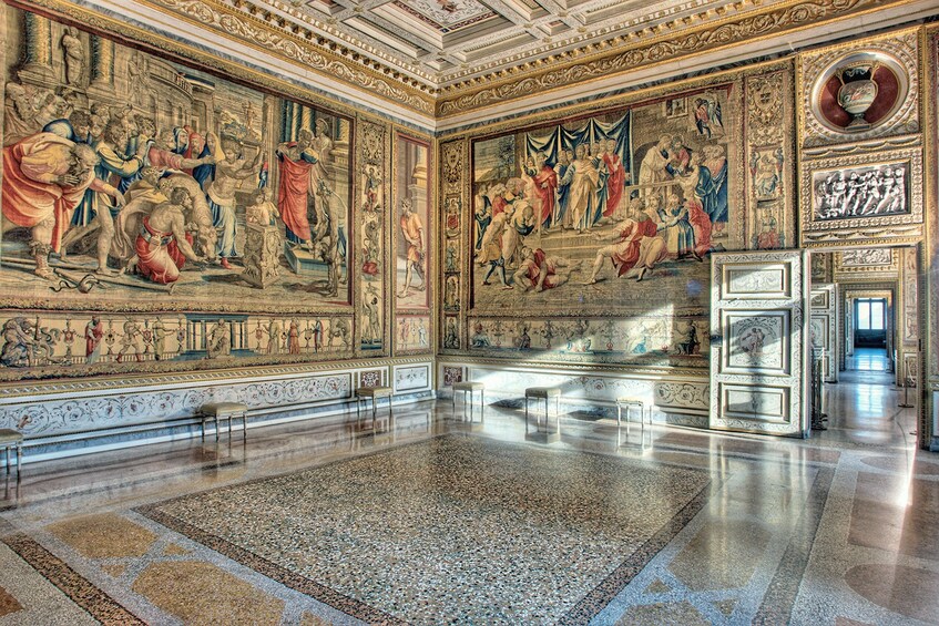 A grand hall with elaborate frescoes and ornate decorations. 2