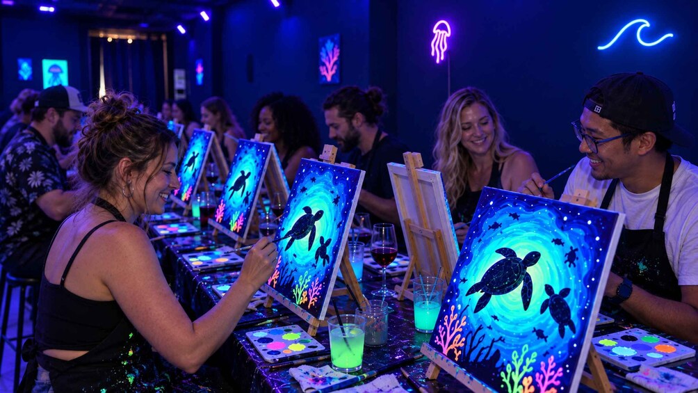 People painting seascapes with turtles on easels in a dimly lit room. 4