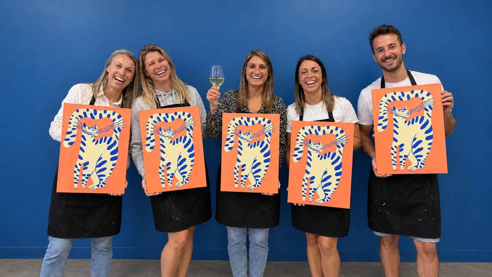 Five people holding orange and blue artwork against a blue background. 2