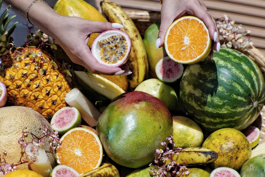 A variety of fruits including a pineapple, mango, watermelon, and oranges. 3