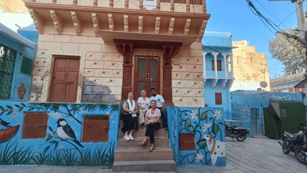 A building with traditional architecture, a blue exterior, and decorative floral patterns. 2