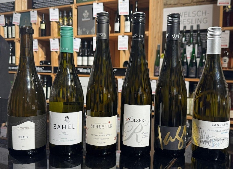 A selection of wine bottles on a shelf in a store. 3