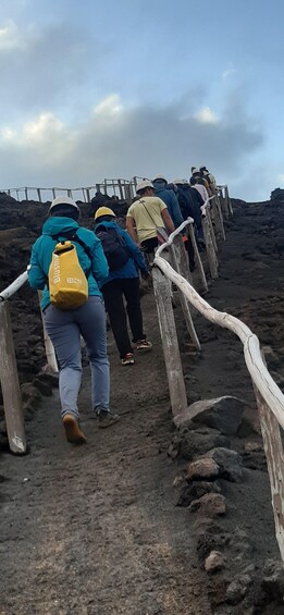 A group of hikers ascending a rocky path with wooden railings. 5