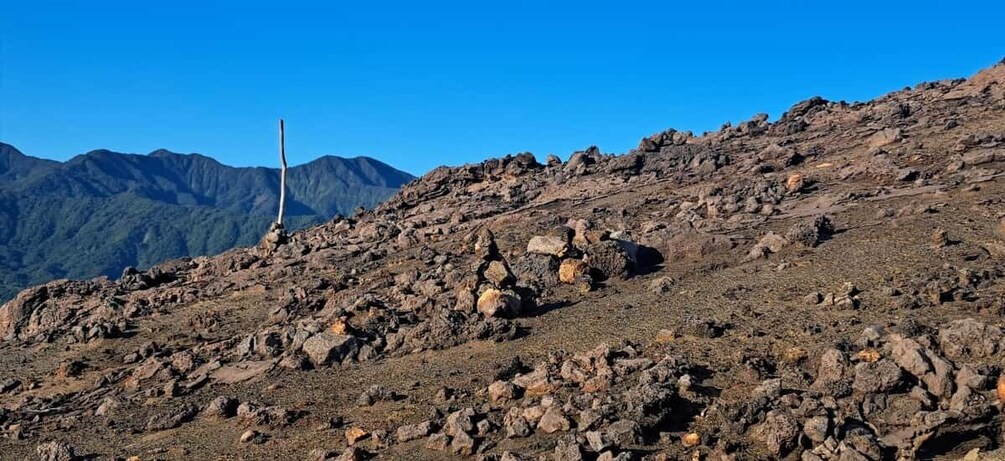 A rocky mountain landscape with a wind turbine. 1