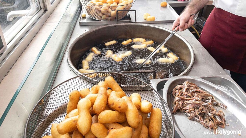 A food stall with fried dough and fish on display. 5