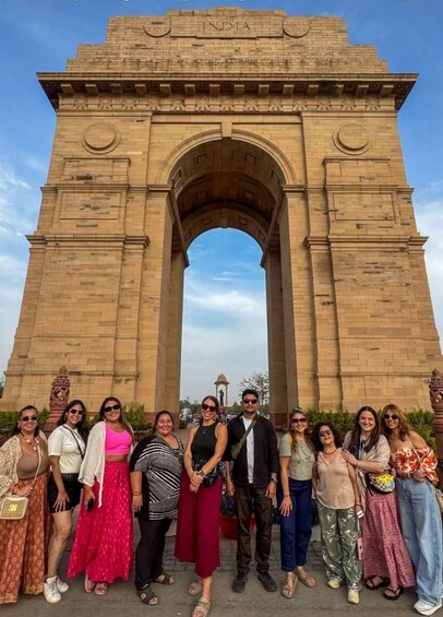 A group of people standing in front of the India Gate. 4