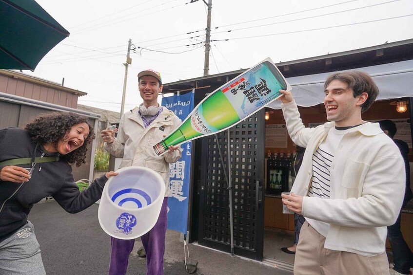 Three people holding a large bottle and a megaphone. 1