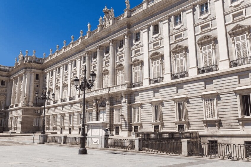 A grand classical building with columns and ornate windows. 1