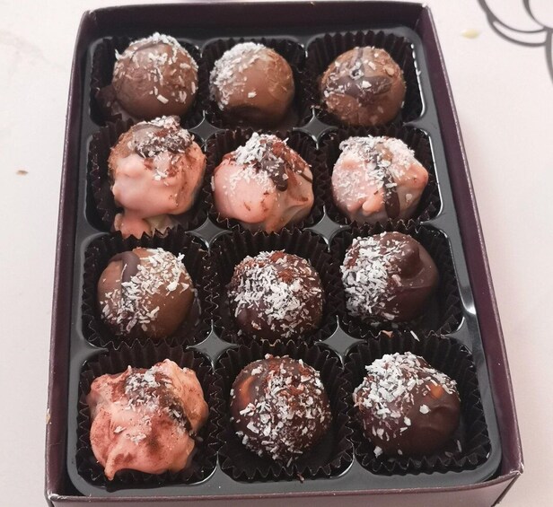A tray of chocolate-covered treats in individual paper cups. 5