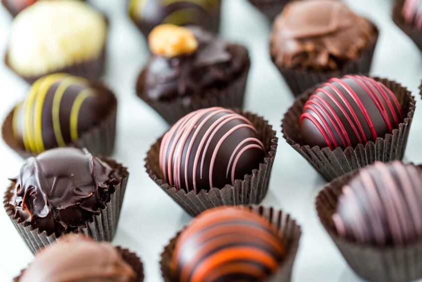 A variety of chocolate truffles in different colors and designs. 1