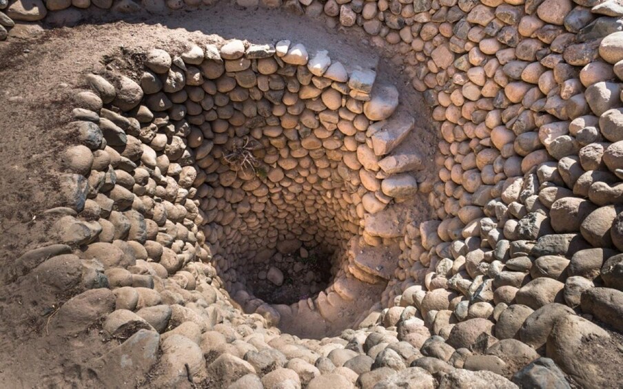 A large, circular stone structure with a central hollow. 2