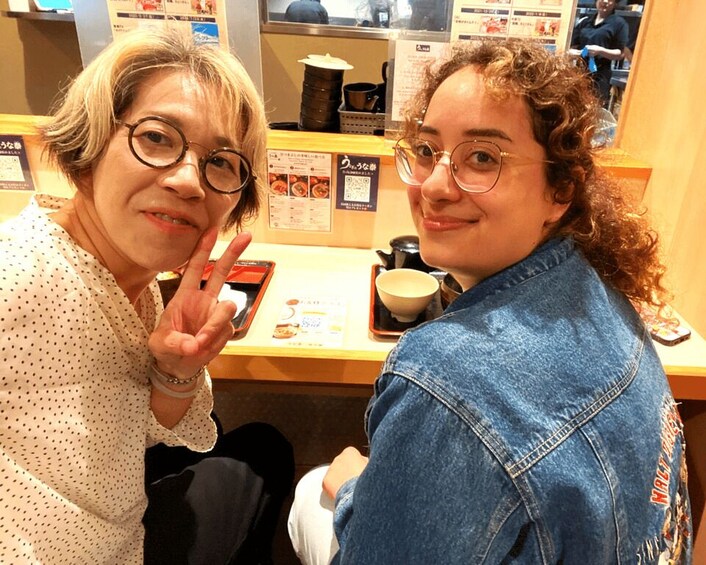Two people sitting at a counter with a menu and a cup. 3