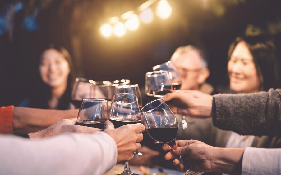 A group of people toasting with wine glasses. 5